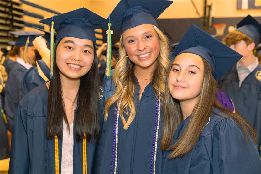 Students wearing blue graduation robes